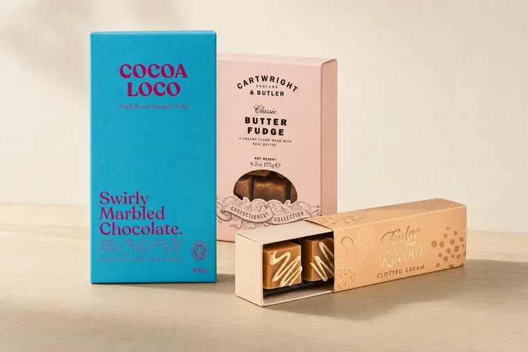 The sweet end: a Cocoa Loco swirly marbled chocolate bar, a box of Cartwright & Butler classic butter fudge, and an open sleeve of Fudge Kitchen clotted cream fudge.