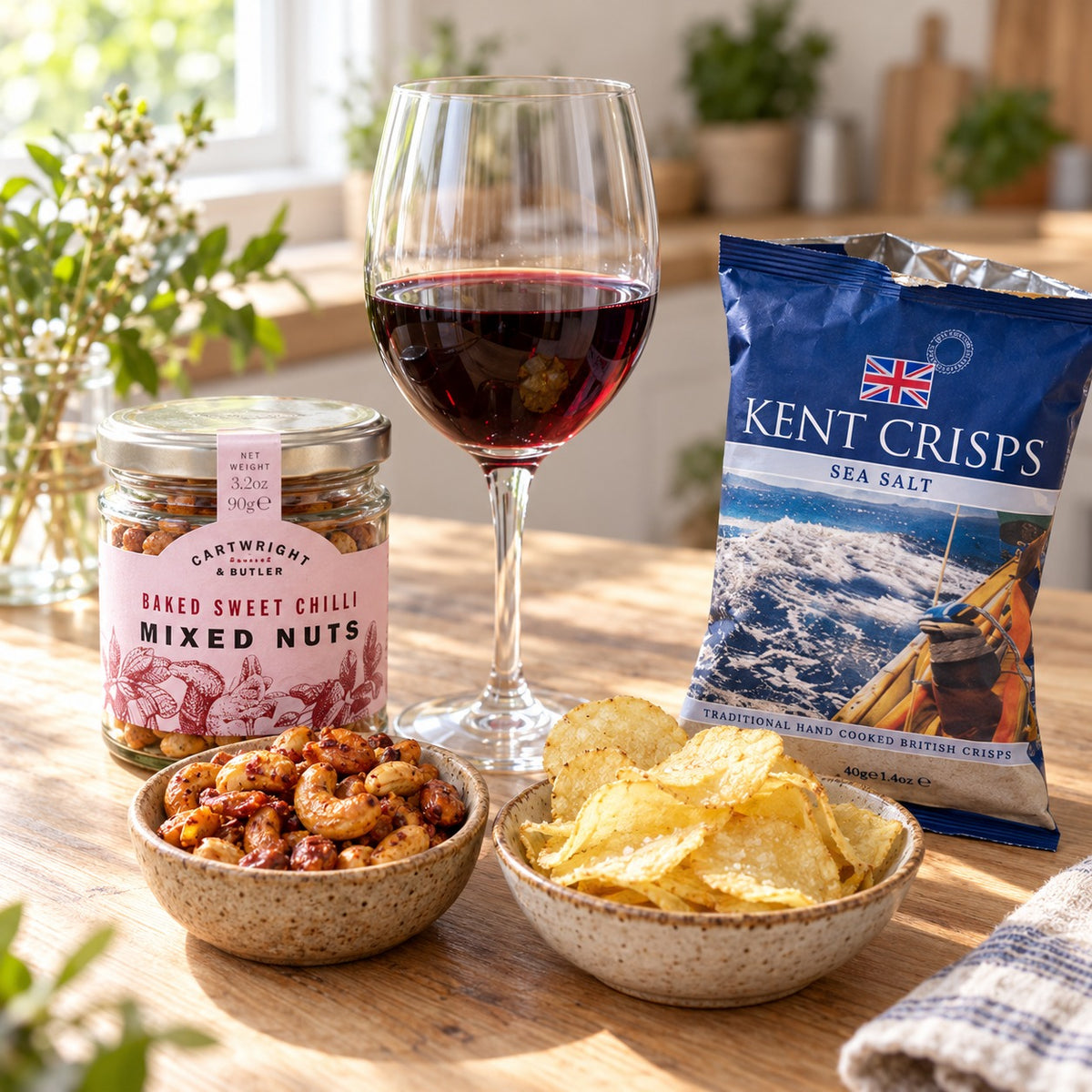 The Banquet Hamper: sweet chilli peanuts and cashews and Kent sea salt crisps with a glass of Merlot