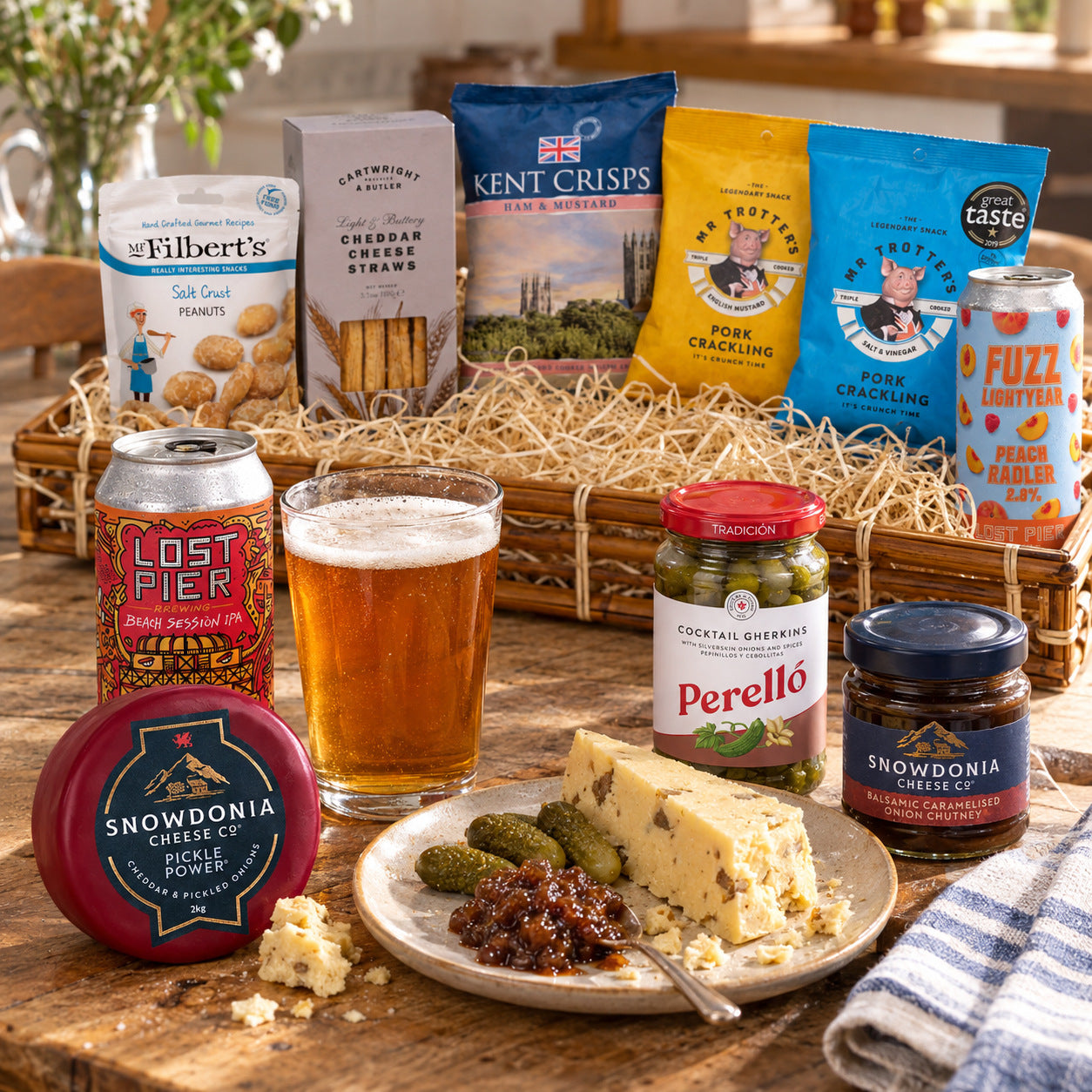 Serving detail from The Ploughman’s Tray: Beach Session IPA 4%, Pickle Power Pickled Onion Cheddar, Cocktail Gherkins, Balsamic Caramelised Onion Chutney. This shows part of the hamper; tableware is not included.